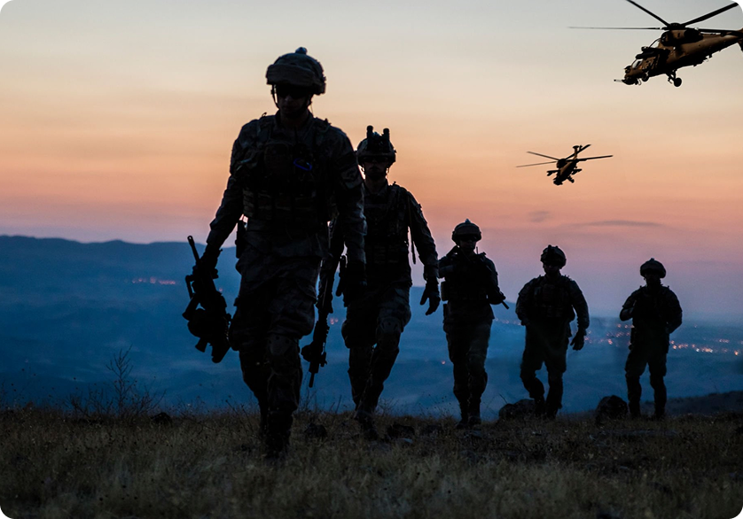 Military personnel silhouettes with helicopters